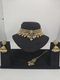 light peach polki choker set with jhumka earings and tikka