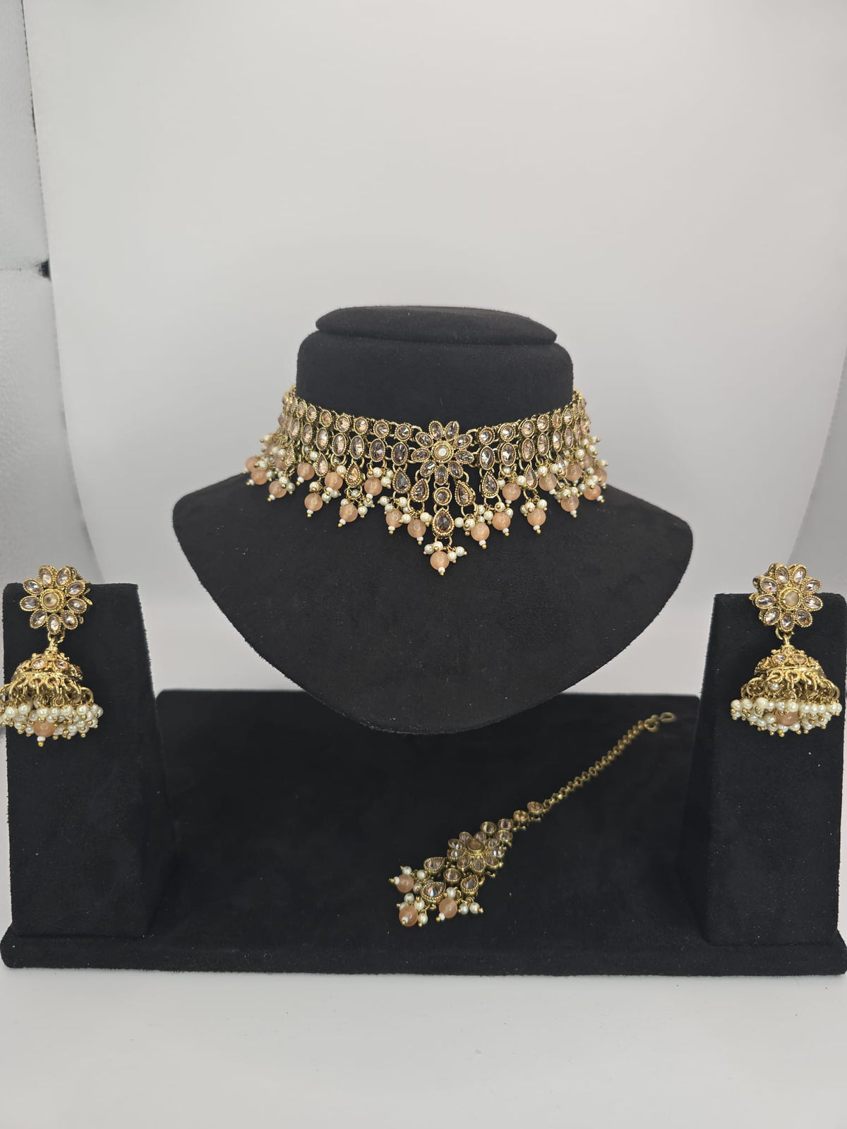 light peach polki choker set with jhumka earings and tikka
