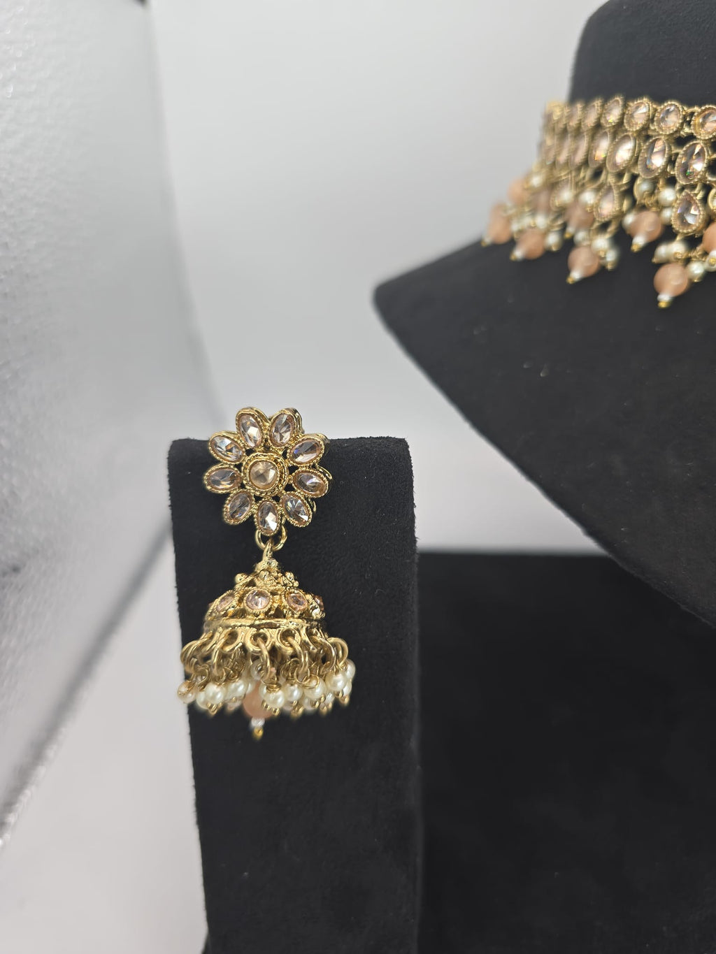 light peach polki choker set with jhumka earings and tikka