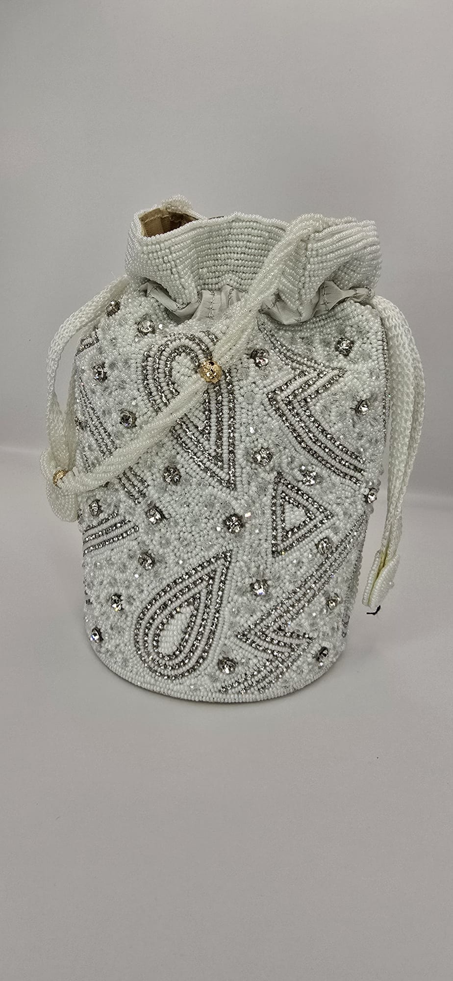 white and silver potli bag