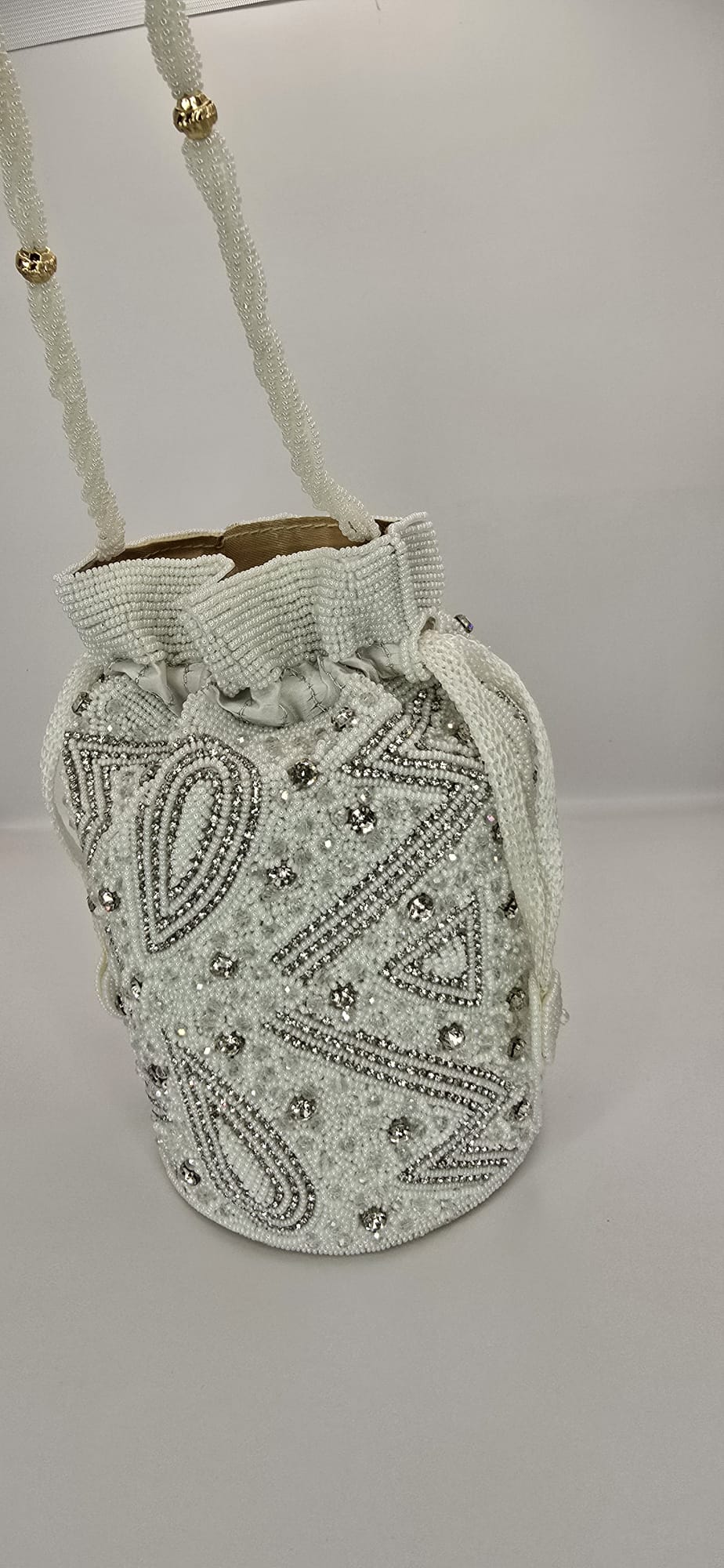 white and silver potli bag