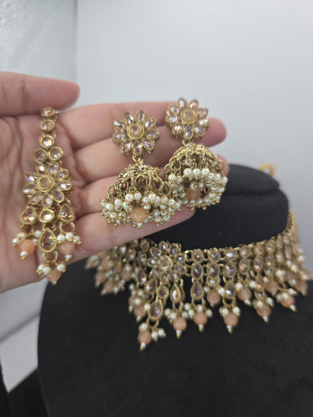 light peach polki choker set with jhumka earings and tikka