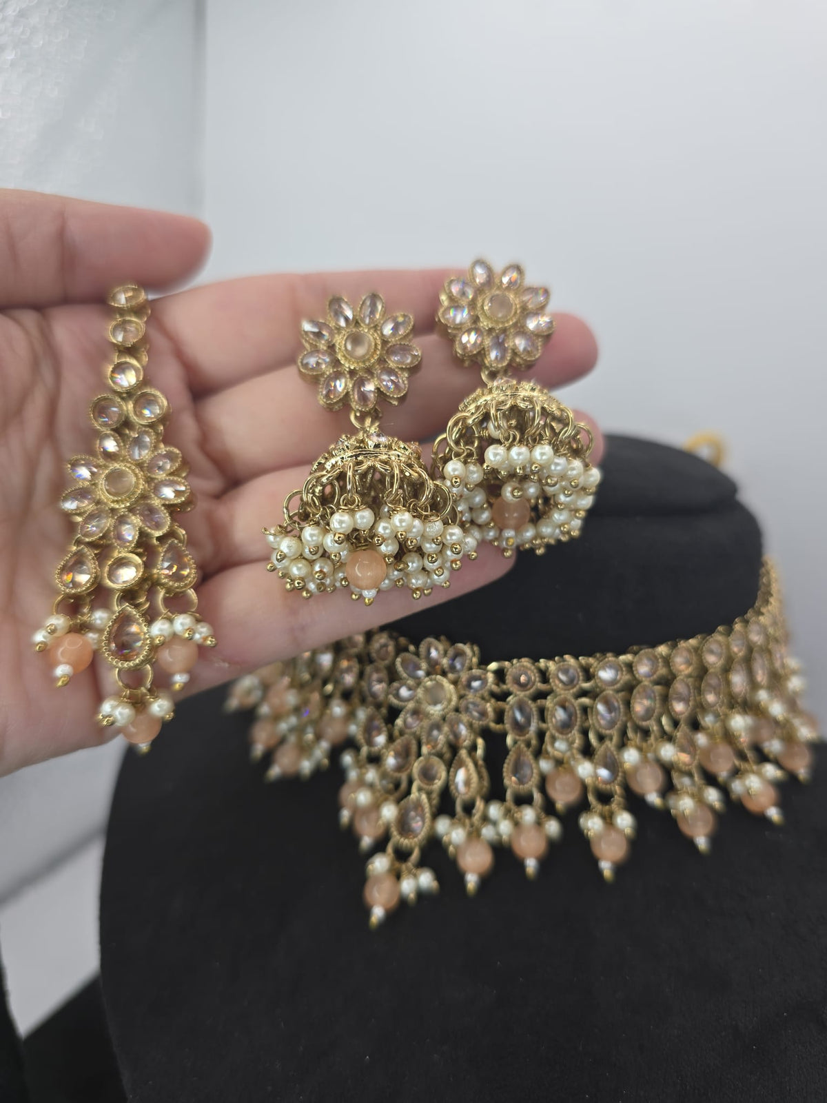 light peach polki choker set with jhumka earings and tikka