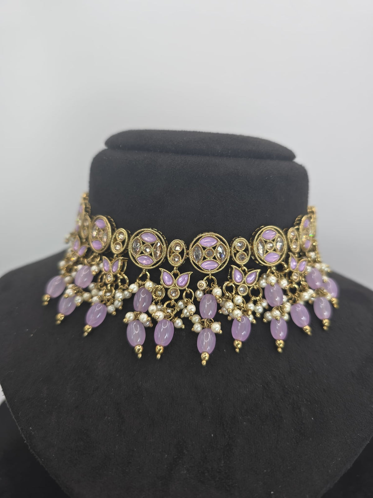 lilac choker with earings and tikka