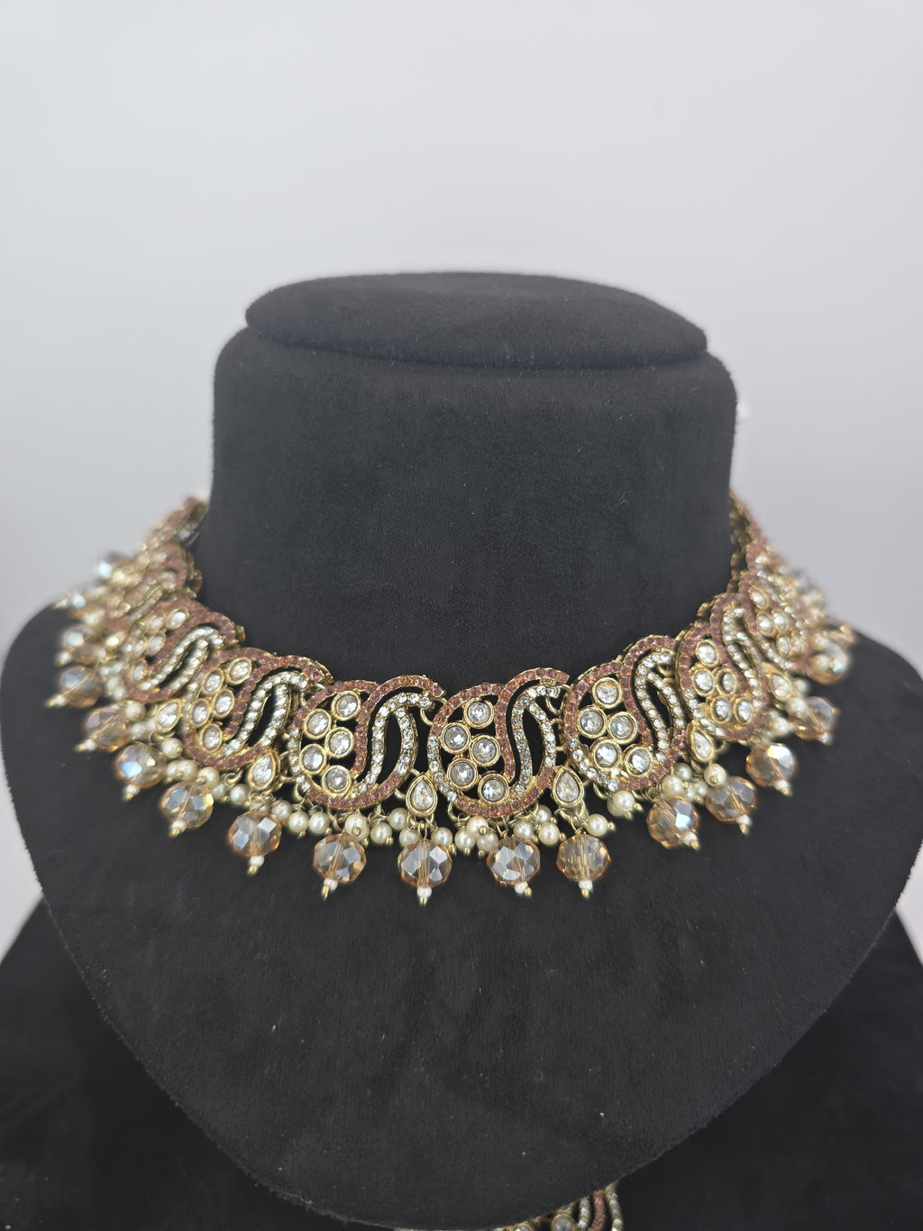 peach set with big earings and tikka