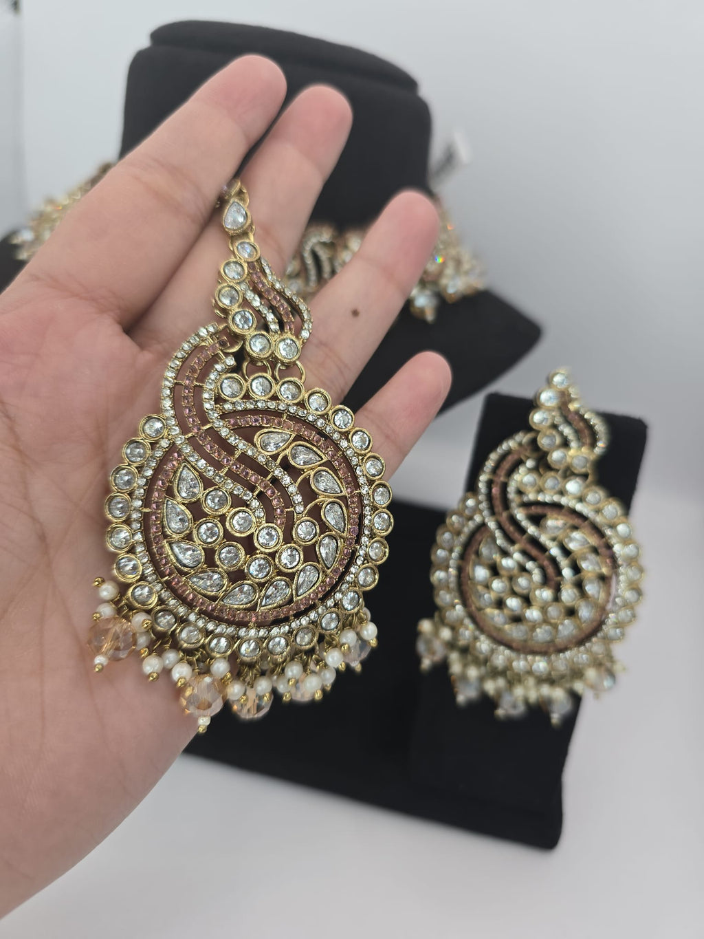 peach set with big earings and tikka