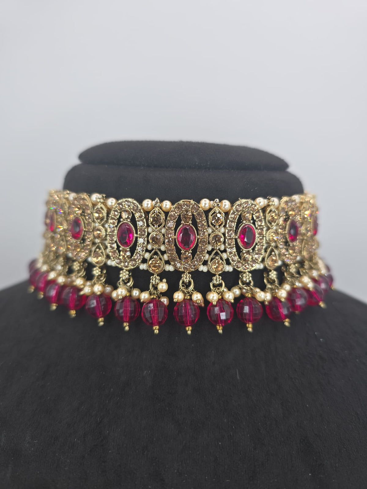 Hot pink choker set with jhumka earings and tikka
